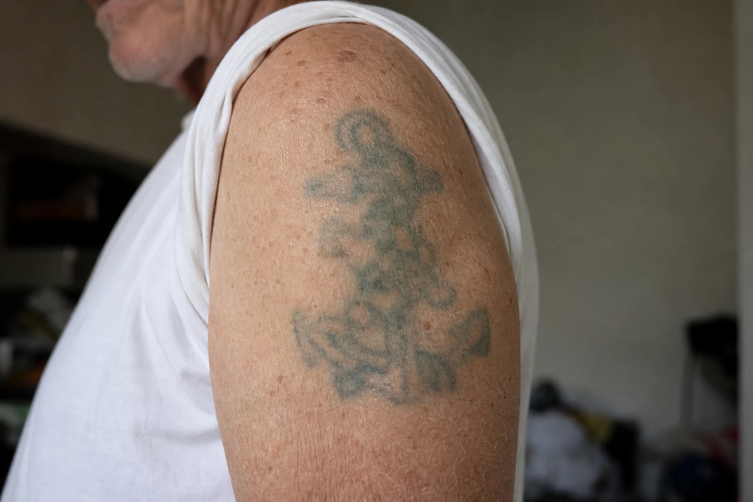A decades-old, faded tattoo