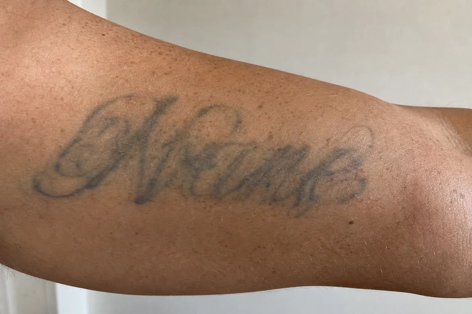 A fine-line name/script tattoo