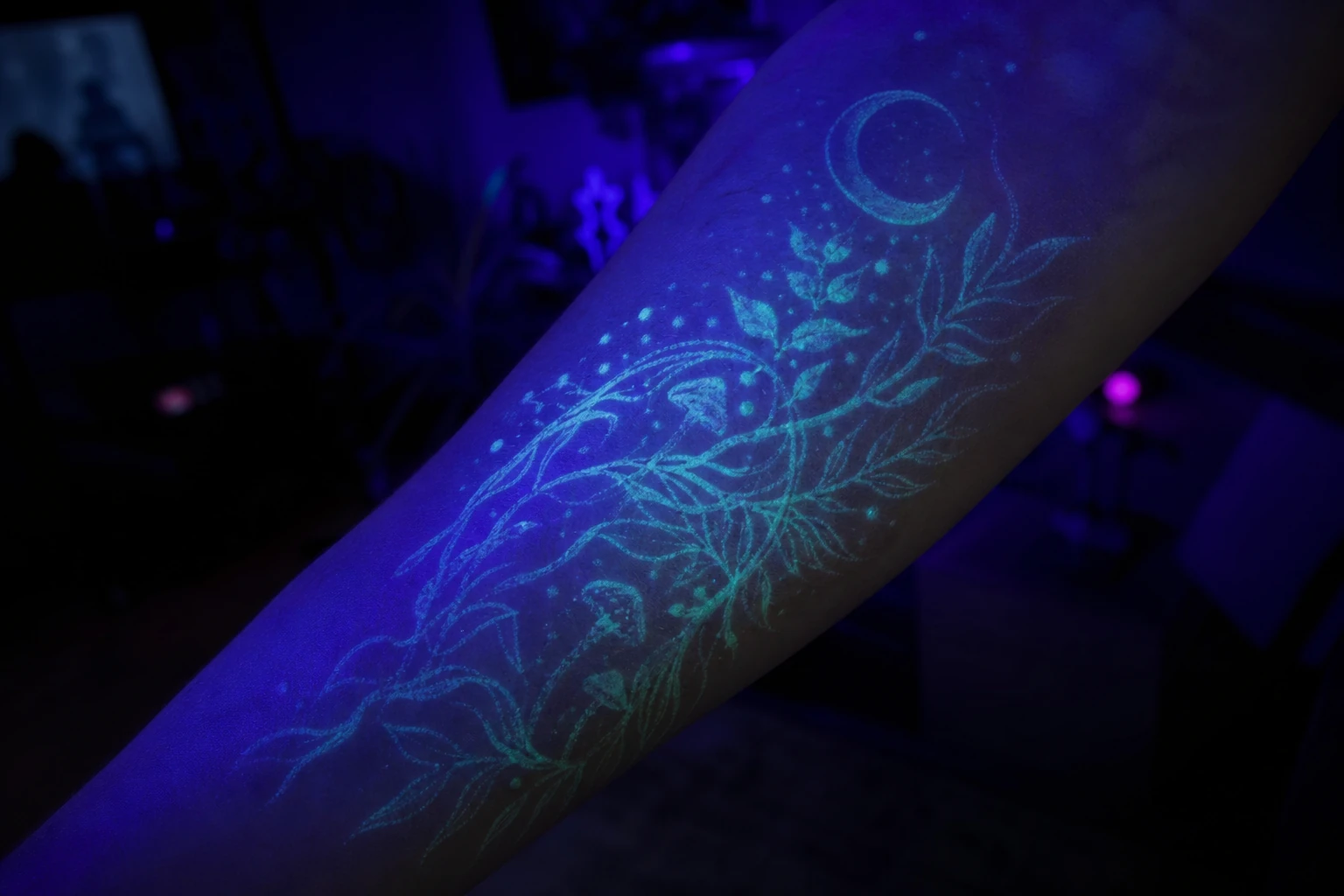 A UV/blacklight-reactive tattoo glowing under UV light
